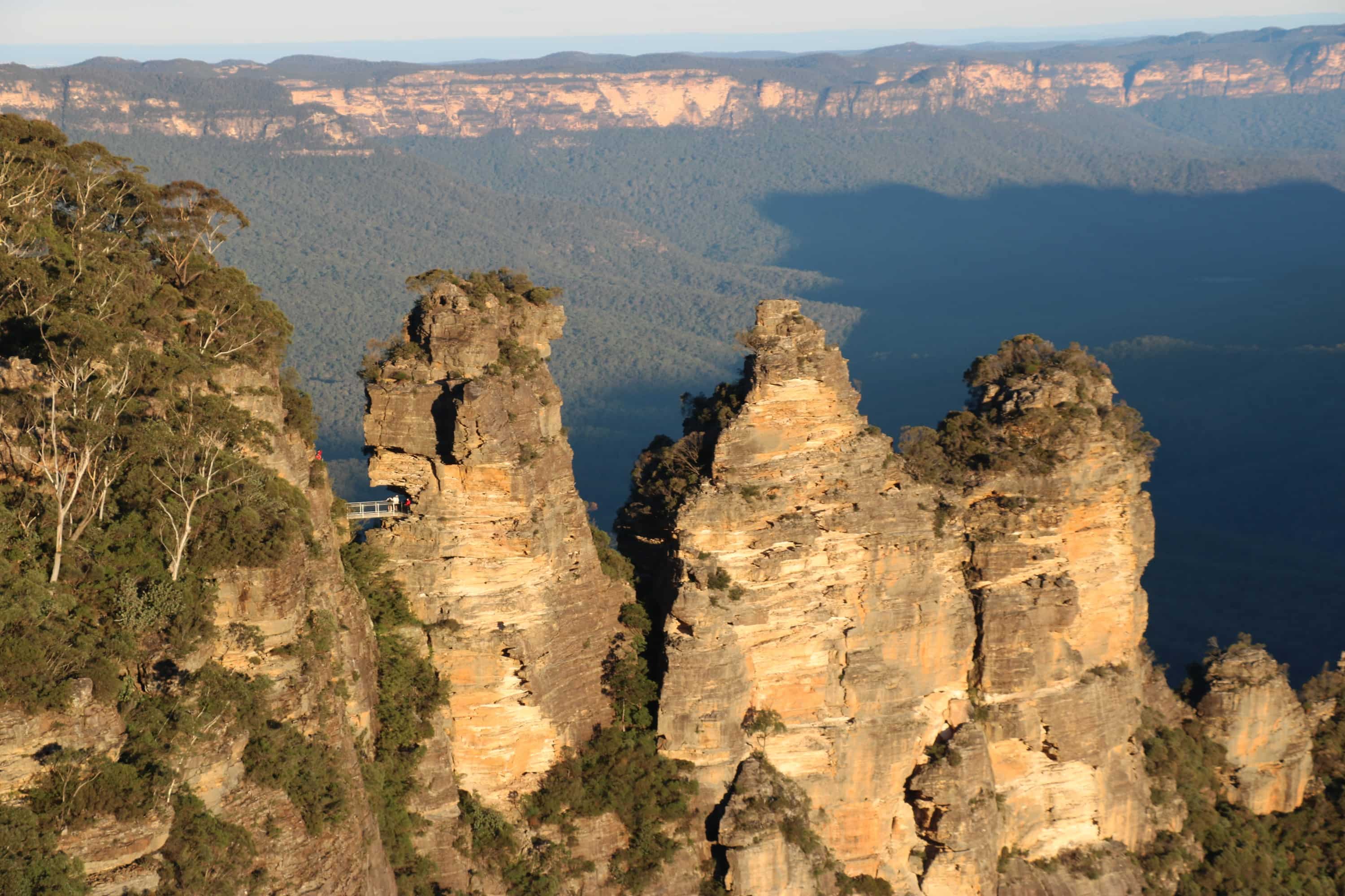 Three pointed sandstone rock formations jutting out from the cliff face