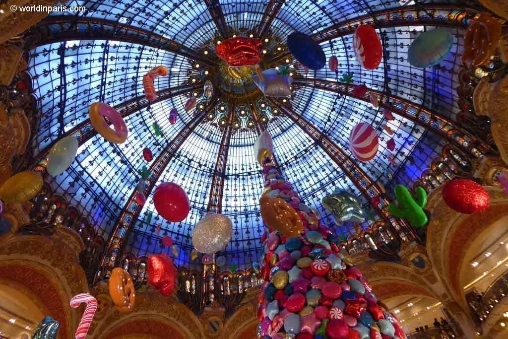 Stained glass dome adorned with Christmas decorations in the Galeries Lafayette