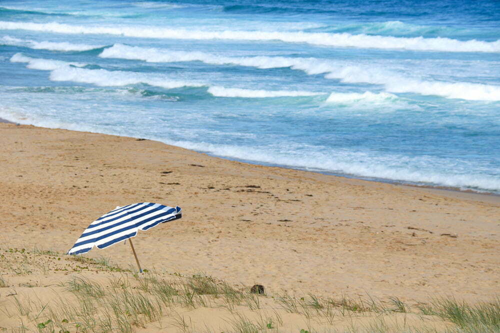 An umbrella on an empty beach