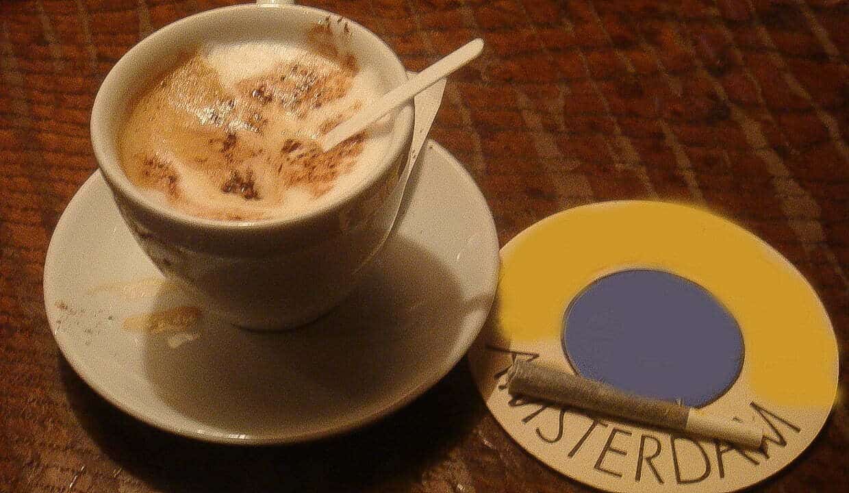 Coffee Shop in Amsterdam A cup of coffee and a joint on a table