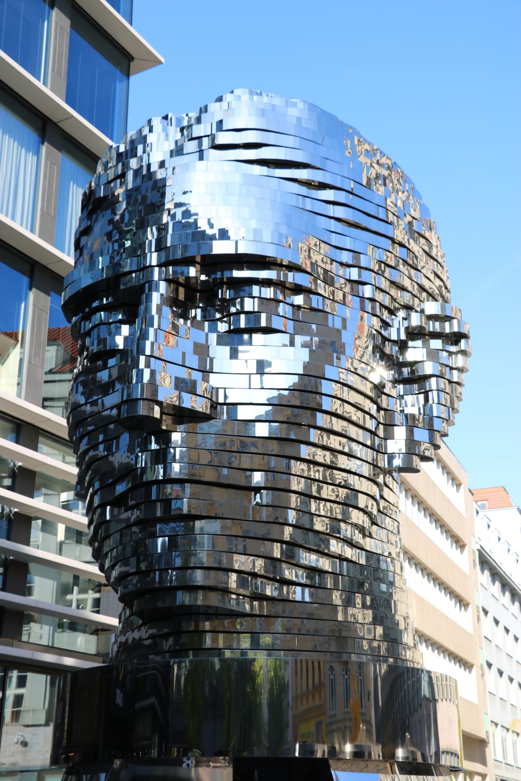 A sculpture of a giant silver head depicting Czech writer Franz Kafka
