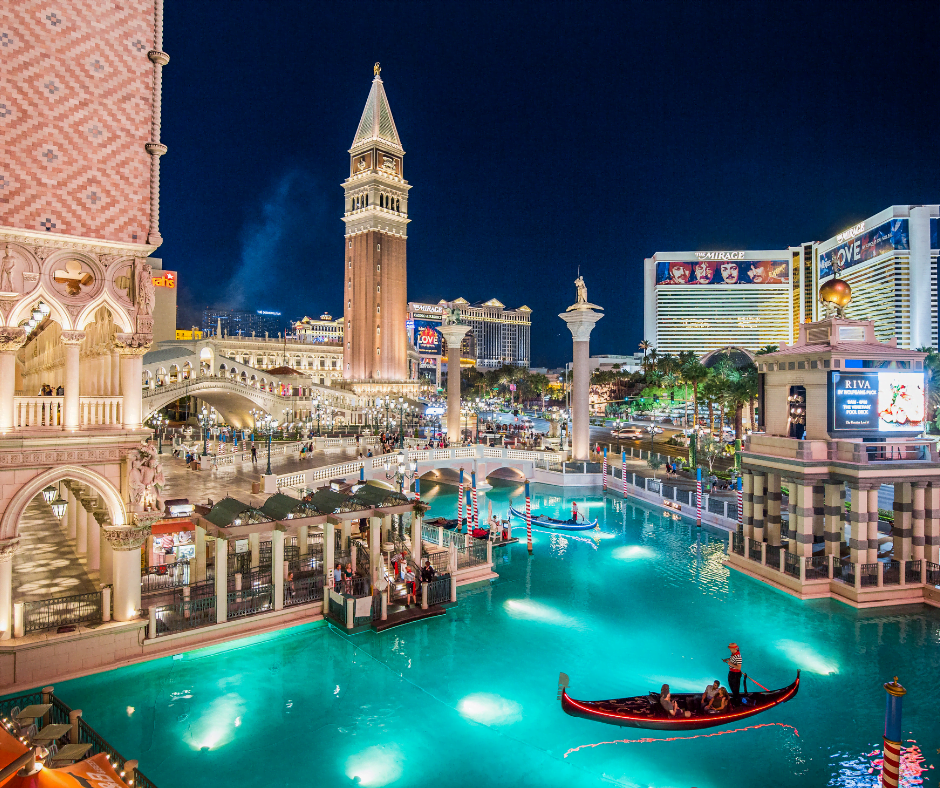 The illuminated water of The Venetian's replica Grand Canal with a gondola boat floating on the water