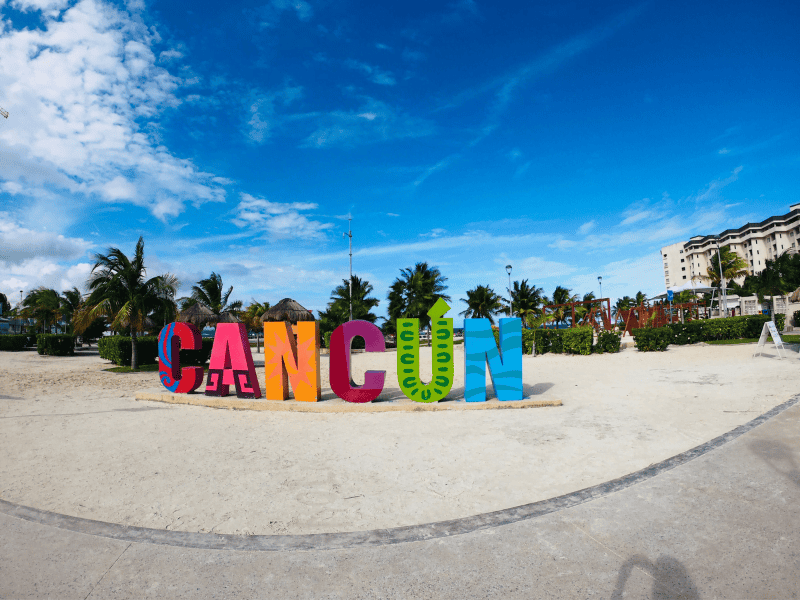 A sign on the beach spelling out Cancun